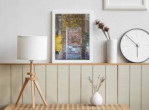 Layers of yellow and green paint cover an old wall with a bricked-up entrance.