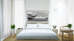 Black and white Canadian mountain scene with low cloud and fine tree-lined ridges.