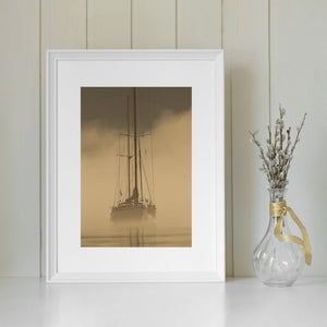 Vertical nautical photograph with tall masts rising above a hazy golden harbour.