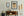 Tall masts and a softly outlined hull emerge through golden coastal mist.
