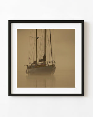 Sailboat in golden morning mist in British Columbia.