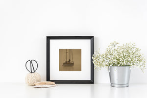 British Columbia sailboat with a dark hull reflected in misty water.