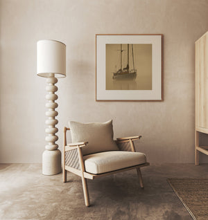 Tranquil sailboat silhouette against a luminous early morning mist, reflecting the peacefulness of British Columbia's intercoastal area.