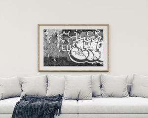 Close urban photograph of overlapping graffiti, drips and weathered wall texture.
