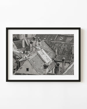 Weathered rooftops and chimneys in Bucharest, photographed in black and white.