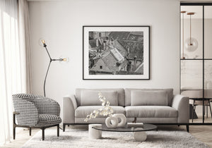 Monochrome city detail with angled roofs, small windows and weathered chimneys.