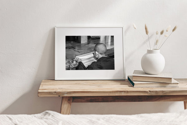 Black and white photo of Buddhist boy studying in a monastery