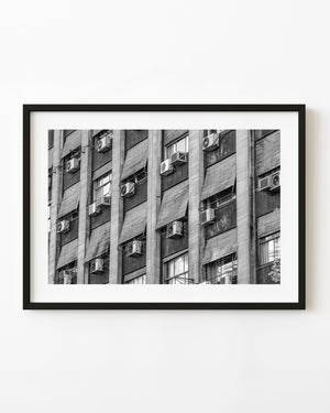 Apartment windows and air conditioners in Buenos Aires, photographed in black and white.