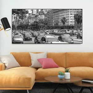 Black and white street photograph of cars, buses and dense avenue traffic.