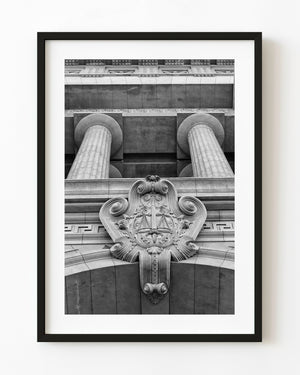 Black and white photograph of Buenos Aires columns and ornate carved scales.