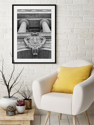 Black and white architectural photograph of columns and carved facade ornament.