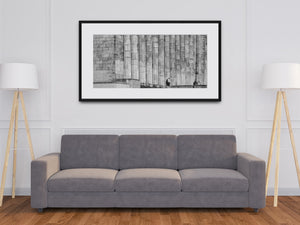 Massive fluted columns and a lone figure in a monochrome Buenos Aires scene.