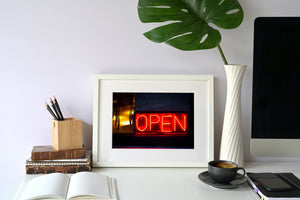 Close urban photograph of an illuminated OPEN sign in Buenos Aires, Argentina.