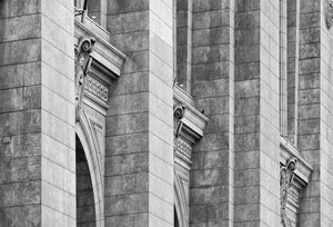 Ornate arches and pale stone bands repeat across a Buenos Aires building facade.
