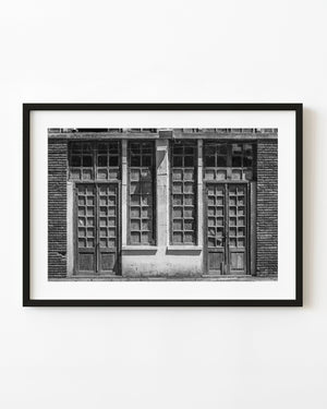 Black and white photograph of weathered doors and windows in Buenos Aires.