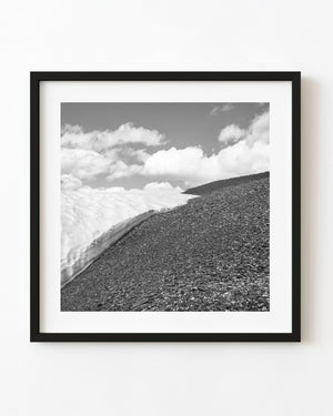 Black and white photograph of a snow edge and rocky slope in the Bugaboo Mountains.