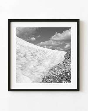 Black and white photograph of a snowfield and rocky slope in the Bugaboo Mountains.