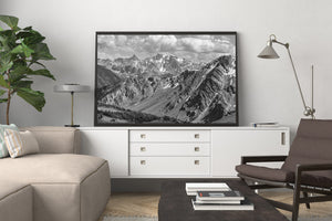 Horizontal black and white landscape of receding mountain ridges and valleys.