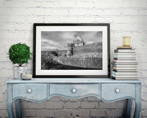 Clouds gather above Cahir Castle’s tower and rugged outer walls.