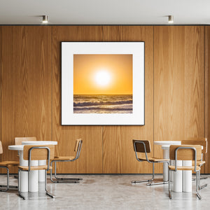 Warm sunlight falls across breaking waves in a California coastal scene.