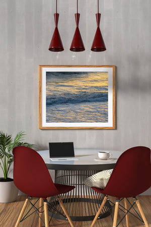 Soft foam and warm highlights trace the surface of moving Pacific surf.