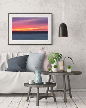Pacific coastal sunset with layered colour and a clear horizontal ocean horizon.