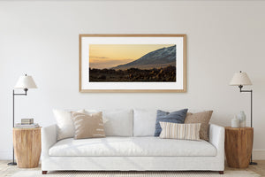 California mountain scene with warm evening sky and shadowed rocky ground.