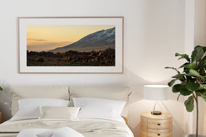 Sunset colour softens the horizon behind dark California mountain terrain.
