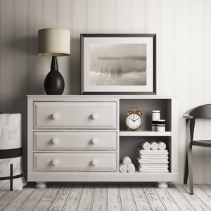 Lake grasses and soft tree reflections create a muted waterside scene.