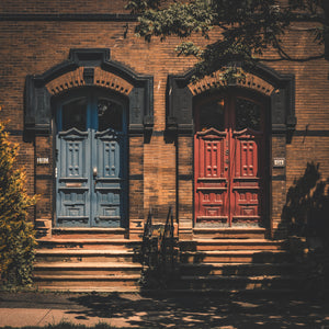 Brick row house entrances with tree shadows