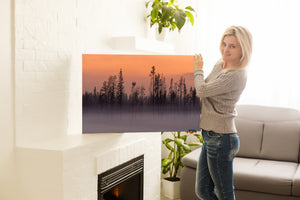 smoke filled landscape with burned trees at sunset Northwest Territories