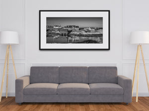 Harbor reflections beside granite shoreline