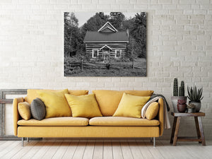 Historic rural Ontario cabin with weathered wooden fence black and white