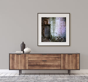 Aging wooden door set into weathered masonry wall
