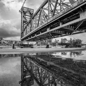 Low angle view of steel lift bridge with puddle reflection Ontario