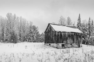 weathered wooden barn covered in snow Canada rural scene
