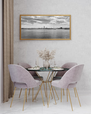 Calm water and industrial skyline in black and white photography