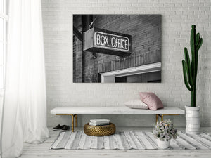 Neon box office sign mounted on old brick building Toronto