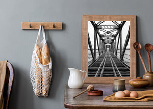 Symmetrical railroad tracks inside industrial bridge structure