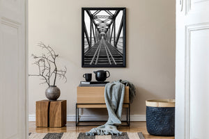 Receding steel truss bridge over water in Quebec