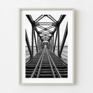 Black and white railway bridge in Quebec with centered vanishing point