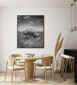 vintage tractor remains in rural field black and white photography