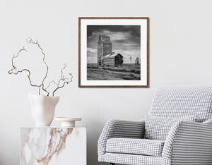 Old wooden grain elevator standing alone on Saskatchewan prairie farmland