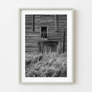 Abandoned farm grain elevator ladder on prairie building Saskatchewan