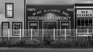 Wooden storefront architecture in Dawson City Yukon photographed in monochrome