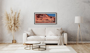 Canyon de Chelly landscape showing sculpted red rock faces against blue sky.