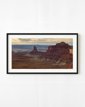 Red buttes rise beneath golden clouds in Canyonlands National Park, Utah.
