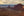 A wide Utah desert landscape with red sandstone towers and a softly glowing evening sky.