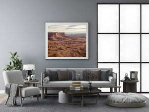 Panoramic Utah landscape with a red mesa and deeply textured desert foreground.