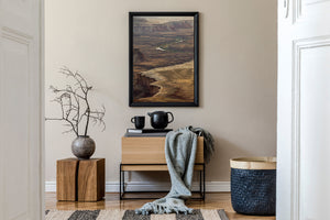 Pale desert ledges and dark ravines descend toward a winding Canyonlands river.